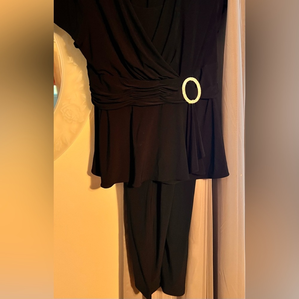 Elegant black pant suit with big rhinestone button.  This suit is beautiful.